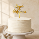 Aged to Perfection Gold Mirror Acrylic cake topper displayed on a cake