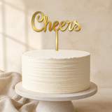 Cheers Gold Mirror Acrylic cake topper displayed on a cake
