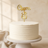 Cheers To 60 Gold Mirror Acrylic cake topper displayed on a cake