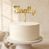 Finally Gold Mirror Acrylic cake topper displayed on a cake