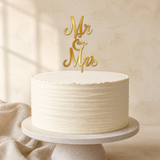 Mr & Mrs Gold Mirror Acrylic cake topper displayed on a cake