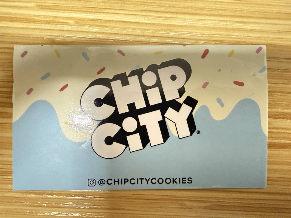 Full-color Chip City logo printed on a metal business card